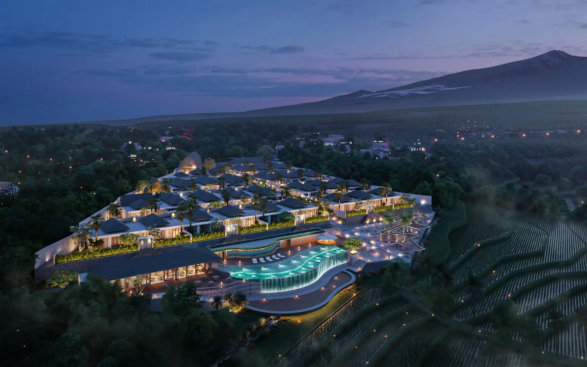 Hillside resort villas around a lit pool at dusk